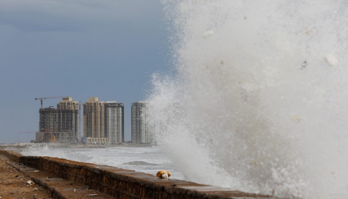View of residential buildings as the rising waves splash, before the arrival of the cyclonic storm, Biparjoy, over the Arabian Sea, at Clifton Beach, in Karachi, June 13, 2023. — Reuters