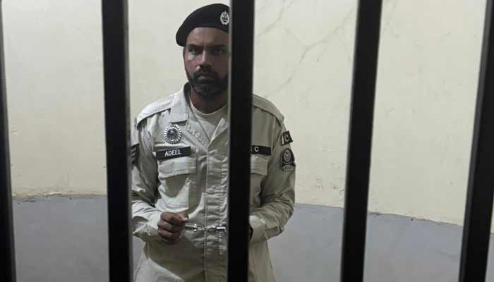 This image shows a cop, suspected of harassing a woman in a passenger bus, inside a jail. —X@MaryamNSharif
