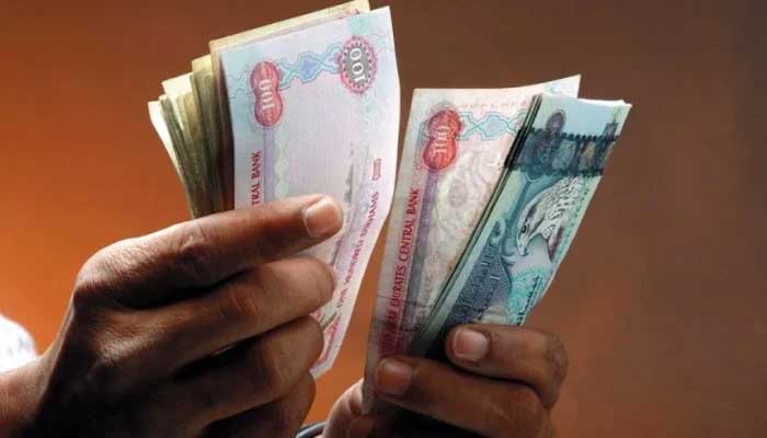 A currency dealers counts UAE dirhams in this undated photo. — Reuters/File