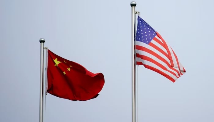 Chinese and US  flags flutter outside a company building in Shanghai, China April 14, 2021. — Reuters