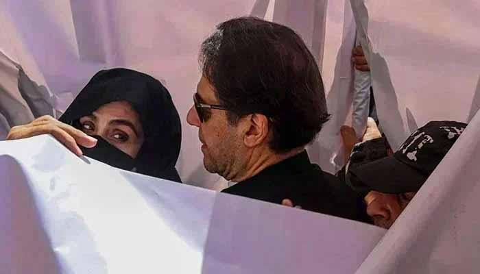 PTI founder Imran Khan with his wife Bushra Bibi during an appearance in a high court in Lahore on May 15, 2023. — AFP