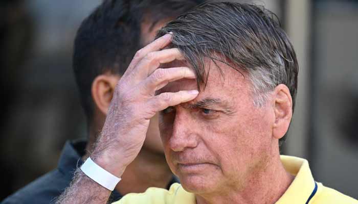 Former Brazilian President Jair Bolsonaro gestures after taking medical tests at DF Star hospital in Brasilia on August 16, 2025.— AFP
