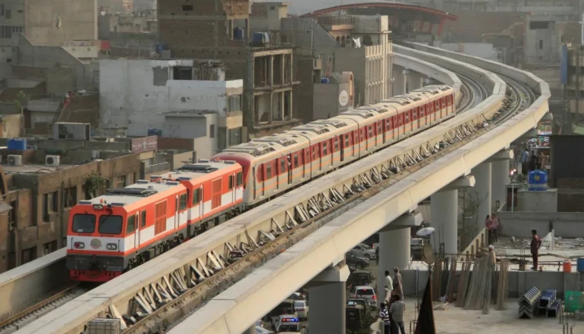 The Orange Line Metro Train on its first test-run, travels along a track in a neighbourhood in Lahore on May 16, 2018. — Reuters
