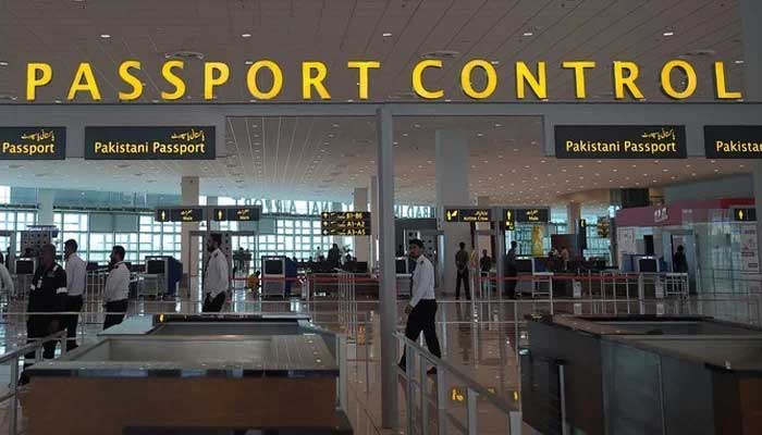 Pakistani airport staff walks through the Islamabad International Airport on the outskirts of Islamabad  on April 26, 2018. — AFP