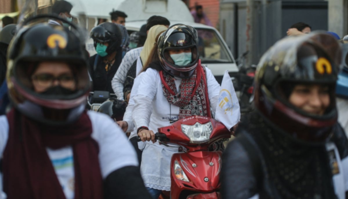 Women bikers participate in a women bike rally in Karachi. — AFP