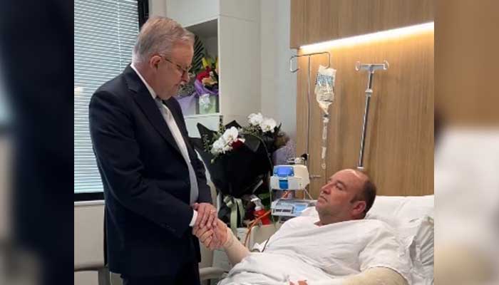Australia´s PM Anthony Albanese meets meeting Ahmed al Ahmed, the man who disarmed one of the attackers during the Bondi beach attack, in hospital in Sydney on December 16, 2025. — X@AlboMP