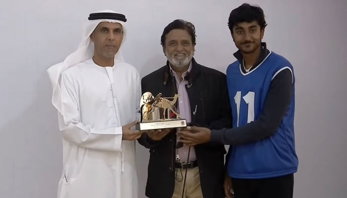 Ahsan Yaseen receives the Golden Camel Trophy for winning the Youth Camel Race at the 54th Sheikh Mohammed bin Zayed Camel Racing Festival in Sharjah, UAE, December 28, 2025. — Reporter