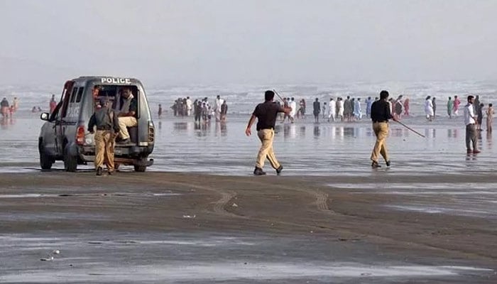 This undated image shows Karachi police personnel patrolling Seaview beach as part of security arrangements. — ONLINE/file