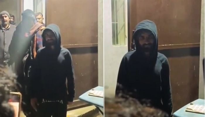 Man alleged to have climbed the university wall to get inside the girls hostel at Quaid-e-Azam University can be seen in this screengrab taken from a video. — Reporter