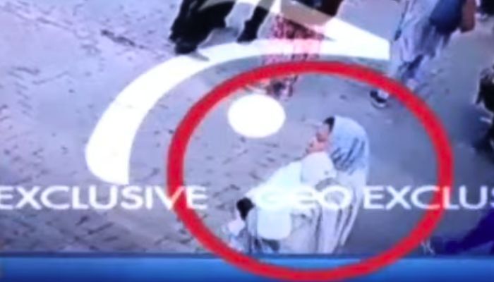 Woman takes baby outside the hospital. — screengrab/Geo News