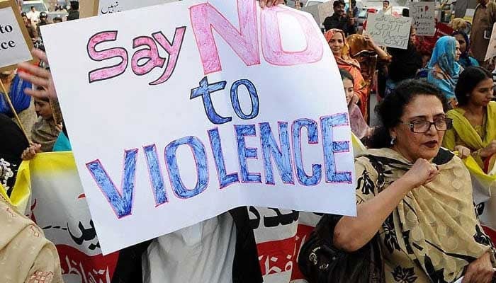 Protesters hold a placard against violence at a protest. — AFP/File