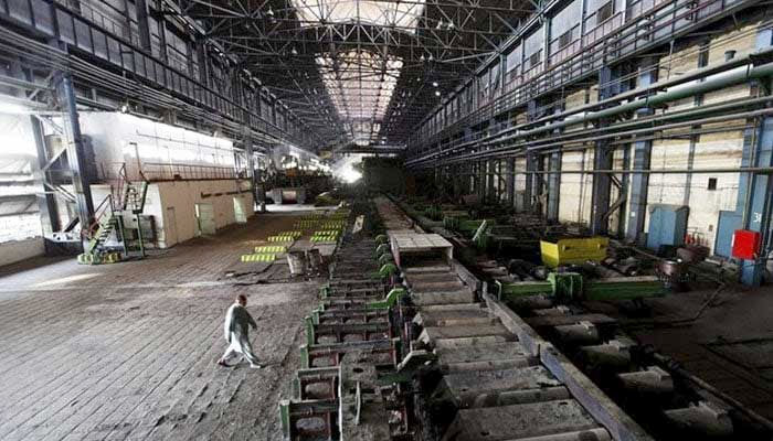 A man walks past machines at the hot strip mill department of the Pakistan Steel Mills (PSM) on the outskirts of Karachi on February 8, 2016. — Reuters