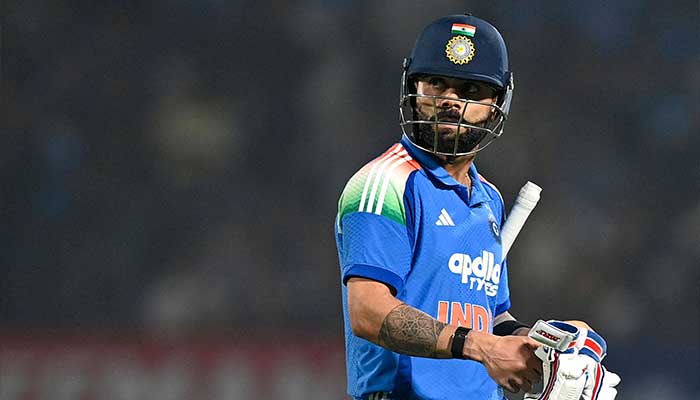 Indias Virat Kohli walks back to the pavilion after his dismissal during the first one-day international (ODI) cricket match between India and New Zealand at the Kotambi Stadium in Vadodara on January 11, 2026. — AFP
