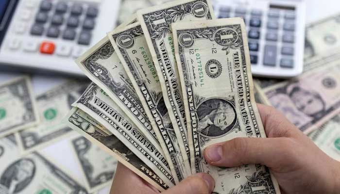 A person counts dollar notes in this illustrative image taken on May 30, 2022. — Reuters