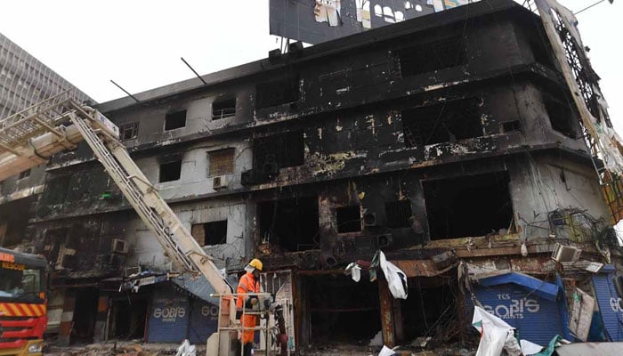 A rescue workers is pictured during a search operation at Gul Plaza shopping centre in Karachi on January 23, 2026. — INP