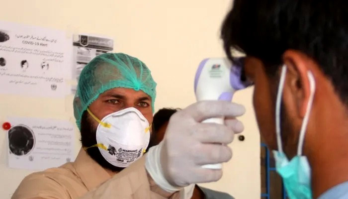 This undated image shows health official checking the body temperature of passengers. — Reuters