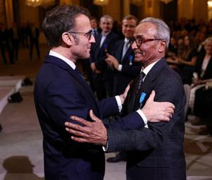 Read all about it! Macron gives honour to last newspaper hawker in Paris