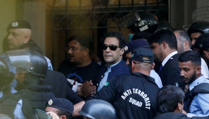 Security officers escort former Prime Minister Imran Khan, as he appeared in Islamabad High Court, Islamabad, Pakistan May 12, 2023. — Reuters