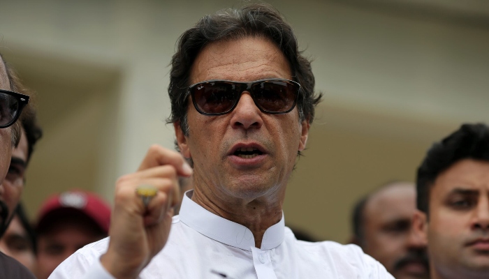 Imran Khan speaks to members of the media after casting his vote at a polling station during the general election in Islamabad, Pakistan, July 25, 2018. — Reuters