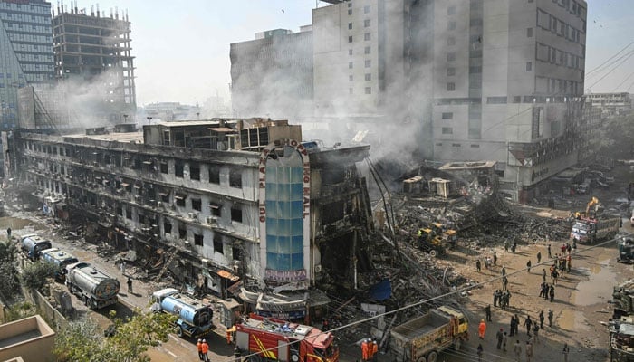 Rescue workers search amid the debris using excavators after a massive fire at a shopping mall in Karachi on January 20, 2026. — AFP