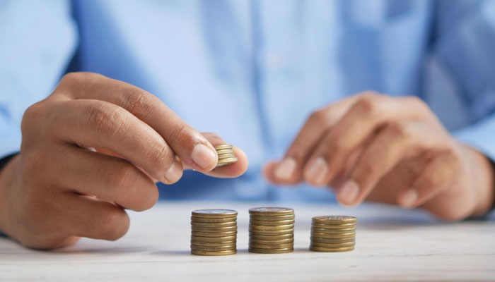 Representational image of a person sorting coins. — Unsplash