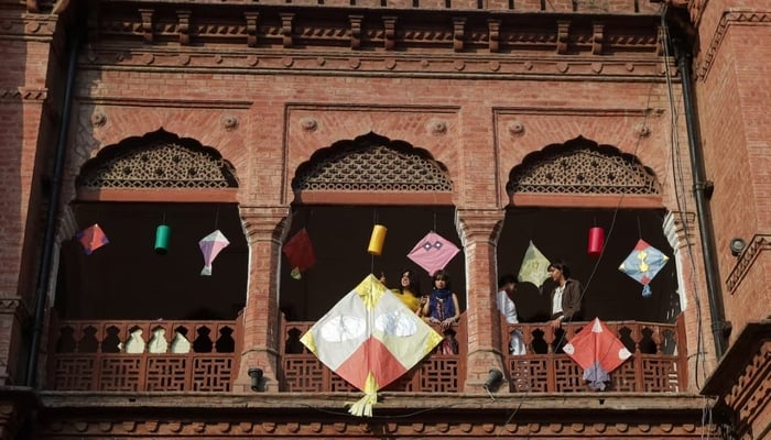 People stand with kites on display to mark Basant, a kite-flying festival, in Lahore, Pakistan February 6, 2026. — Reuters