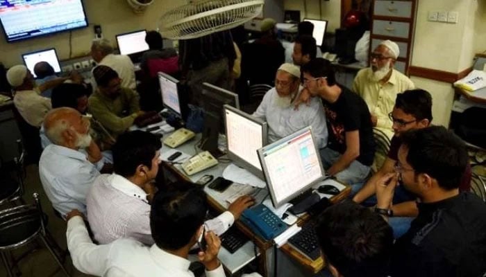 Employees working in an office. — AFP/File