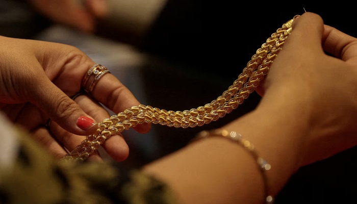 Representational image shows a customer holding a gold chain at a jewellery store in Mumbai, India, January 30, 2026. — Reuters
