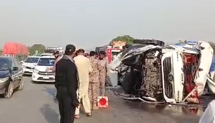An oil tanker lies overturned after the accident on the M-9 motorway as rescue personnel and law enforcement officials inspect the scene on February 13, 2025. — Reporter