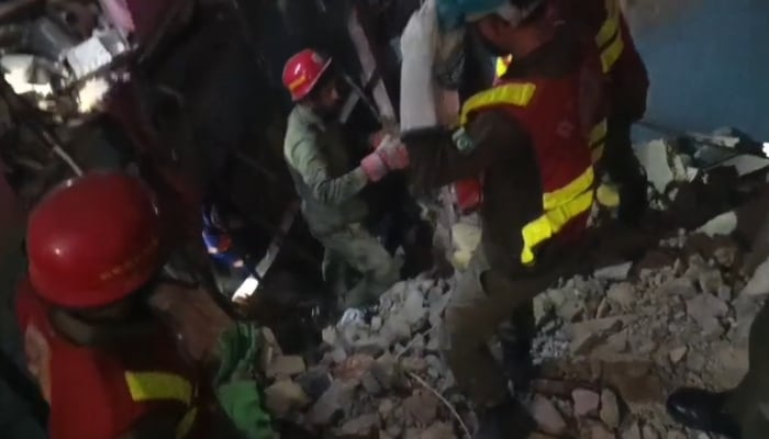 Rescue personnel at work at the site of a building collapse in Karachi, on February 19, 2025. — Geo News