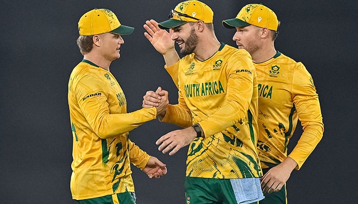 South Africas captain Aiden Markram (centre) celebrates with teammates Ryan Rickelton (left) and David Miller (right) after their teams win at the end of the 2026 T20 Cricket World Cup Super Eights match between India and South Africa at the Narendra Modi Stadium in Ahmedabad on February 22, 2026. — AFP