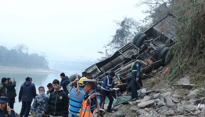 Rescuers pictured alongside overturned bus in Nepal on February 23, 2026. — X@DDNewslive