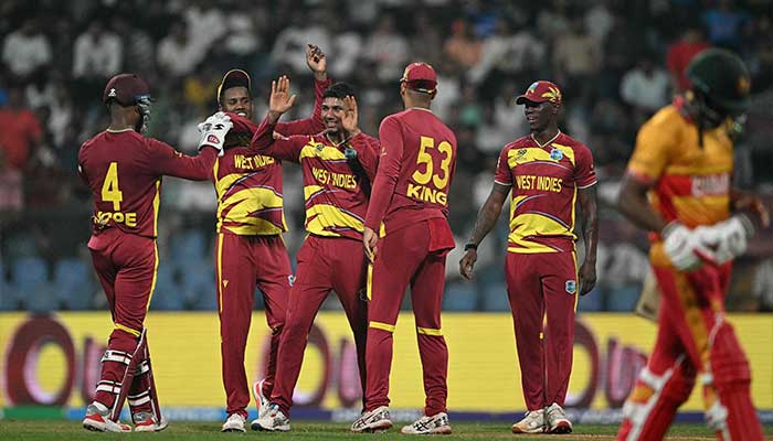 West Indies Gudakesh Motie (C) celebrates after taking the wicket of Zimbabwes Tashinga Musekiwa during the 2026 ICC Mens T20 Cricket World Cup Super Eights match between West Indies and Zimbabwe at the Wankhede Stadium in Mumbai on February 23, 2026. — AFP