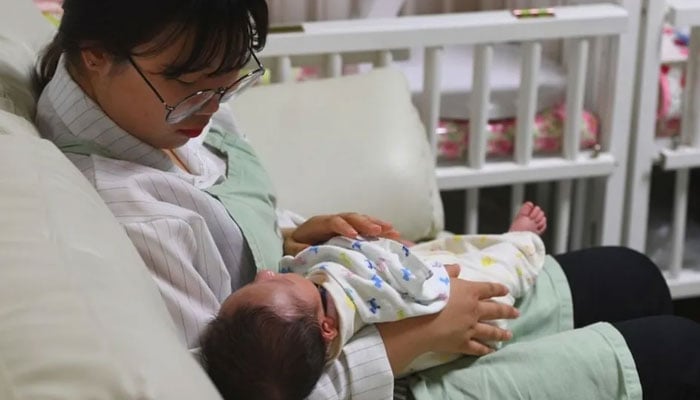 A South Korean woman cradles a baby. — AFP/File