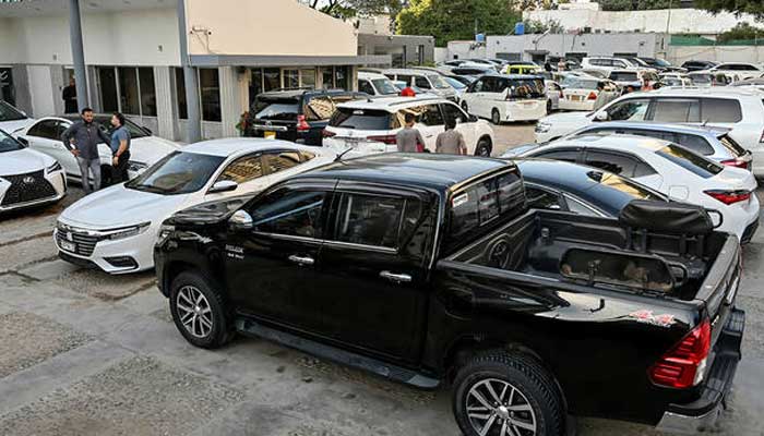 Representational image of vehicles parked at a car dealers showroom in Karachi. — AFP/File