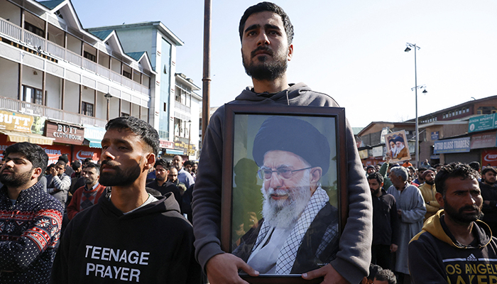 A Muslim man holds a photo of Irans Supreme Leader Ayatollah Ali Khamenei, as they protest after Khamenei was martyred in Israeli-US strikes on Saturday, in Srinagar, Indian Illegally Occupied Jammu and Kashmir, March 1. — Reuters