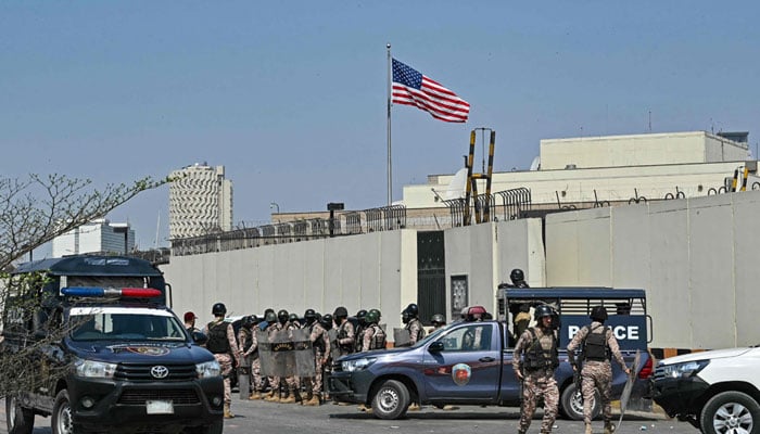 Security personnel stand guard outside the US consulate in Karachi on March 1, 2026 during a clash with protesters as they attempt to storm the premises after the martyrdom of Iran´s supreme leader Ayatollah Ali Khamenei amid US-Israel strikes. — AFP