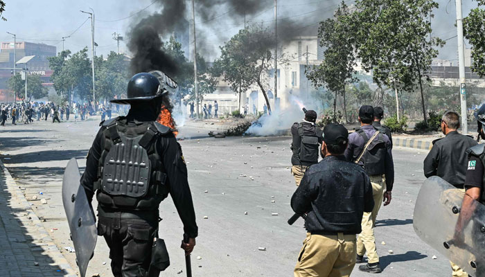 Police fire tear gas at protesters as they stage protests in solidarity with Iran, outside the US consulate in Karachi on March 1, 2026. — AFP