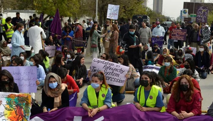 Protesters hold placards as they gather to mark the International Womens Day in Islamabad. — AFP/File