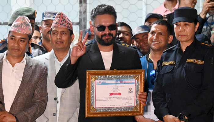 Rastriya Swatantra Party (RSP) election candidate Balendra Shah (C) shows a victory sign after collecting a certificate following his win in parliamentary elections at the counting centre in Damak in Nepals Jhapa district on March 7, 2026.— AFP
