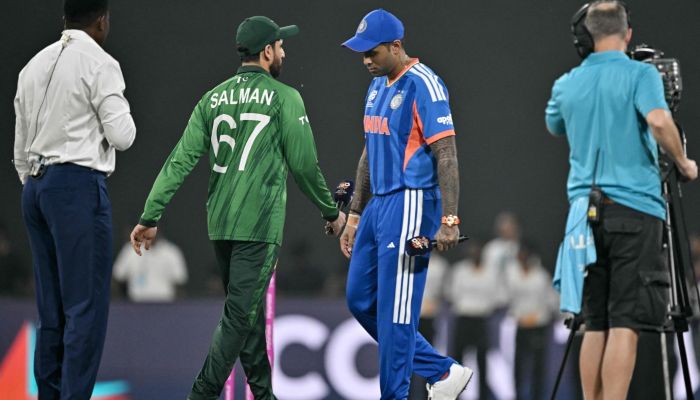 Indias captain Suryakumar Yadav walks past his Pakistan counterpart Salman Agha after the toss before the start of the 2026 ICC Mens T20 Cricket World Cup group stage match between India and Pakistan at the R Premadasa Stadium in Colombo on February 15, 2026. — AFP