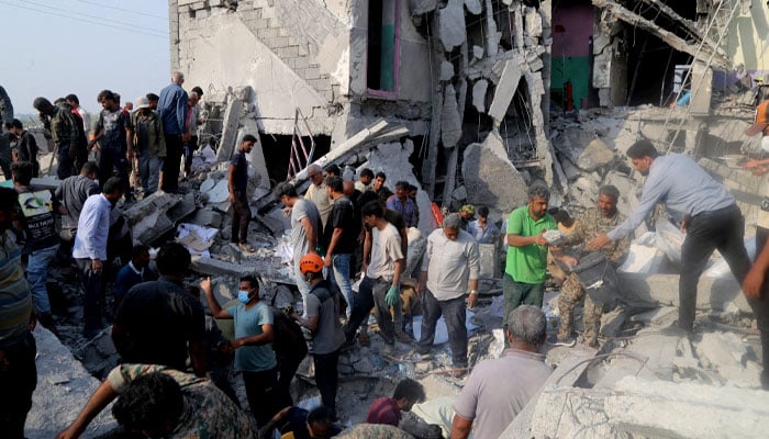 People and rescue forces work following a reported US strike on a school in Minab, Iran, on February 28, 2026. — Reuters