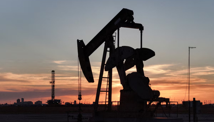 A drone view of a pump jack and drilling rig south of Midland, Texas, U.S. June 11, 2025. — Reuters