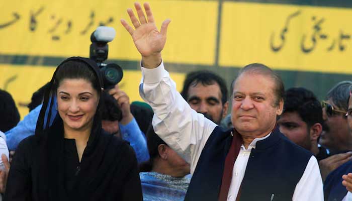 Former prime minister Nawaz Sharif (right) gestures to supporters as his daughter Maryam Nawaz looks on during partys workers convention in Islamabad on June 4, 2018. — Reuters