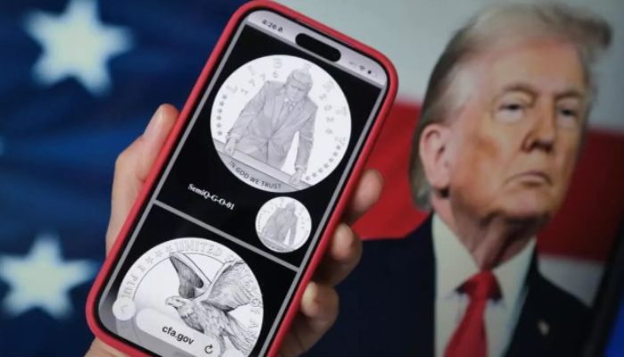 A phone displaying the commemorative gold coin featuring Trump to mark Americas 250th anniversary. — AFP