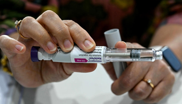 This photograph taken on March 17, 2026 shows obesity doctor explaining Mounjaro GLP-1 self-injectable device at her clinic in Mumbai, India. — AFP