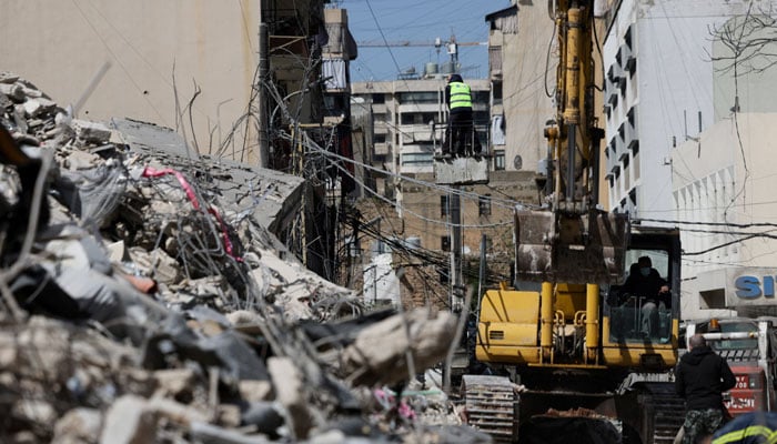 A man uses an excavator to clean debris at the site of an Israeli strike, following an escalation between Hezbollah and Israel amid the US-Israeli conflict with Iran, Zuqaq al-Blat district in central Beirut, Lebanon, March 18, 2026.— Reuters