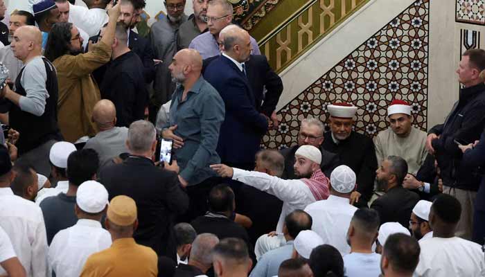 A crowd surrounds Australias Prime Minister Anthony Albanese (not pictured) and Australias Home Affairs Minister Tony Burke during a visit to Lakemba Mosque for Eid al-Fitr in Sydney, Australia, March 20, 2026.— Reuters