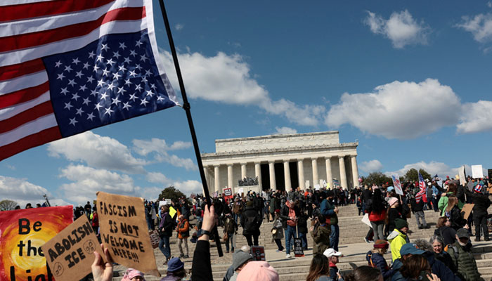 A demonstrator holds an upside-down American flag during a No Kings protest in front of the Lincoln Memorial, amid nationwide demonstrations against US President Donald Trumps administration policies, in Washington, DC, US, March 28, 2026. — Reuters