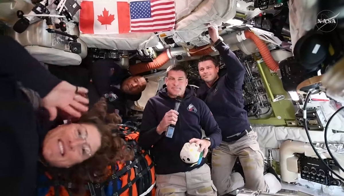 This screengrab taken from a NASA livestream shows Artemis II mission astronauts (L-R) Nasa´s pilot Victor Glover, Nasa commander Reid Wiseman, Canadian Space Agency´s mission specialist Jeremy Hansen and Nasa´s mission specialist Christina Koch as they attend a VIP call with Canadian children from inside the Orion spacecraft while on his way to the moon on April 4, 2026. — AFP